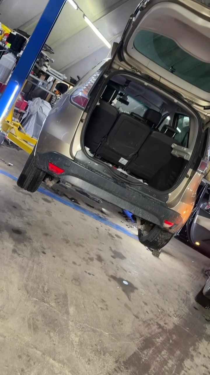 Car in the HYBRID & CAR SERVICE work bay